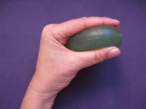 An image of a squeezed Eggesercizer that's use to improve grip strength