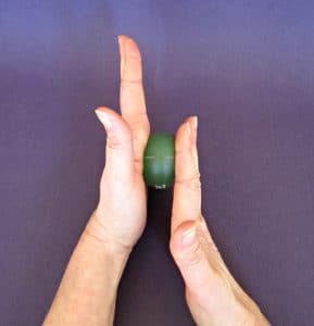 An image of someone using the Eggsercizer® to massage their hands